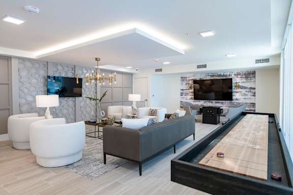 A room with a pool table and a couch.