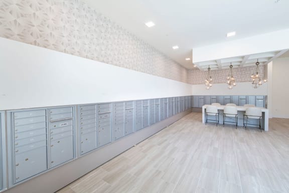 a large room with blue lockers and a table and chairs