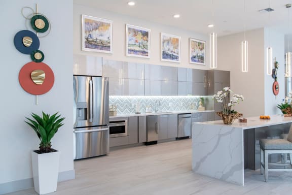 a kitchen with stainless steel appliances and a marble counter top