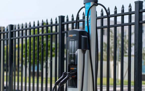 an electric bike parked in front of a fence