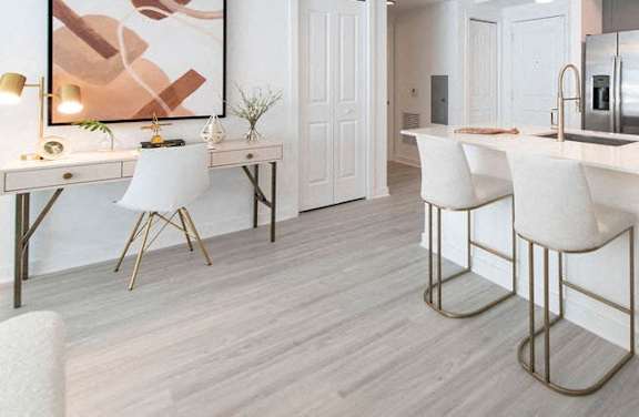 a white kitchen with white chairs and a sink