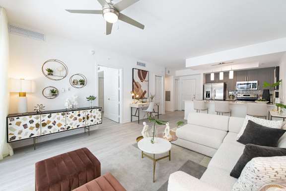 a living room with furniture and a ceiling fan