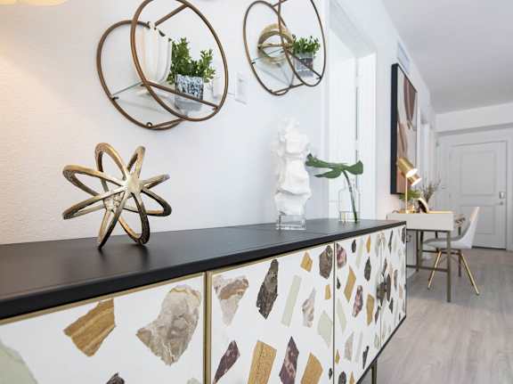 a kitchen with a counter top and several mirrors on the wall