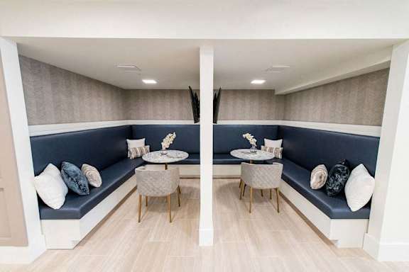 A modern living room with a blue couch and a wooden floor.