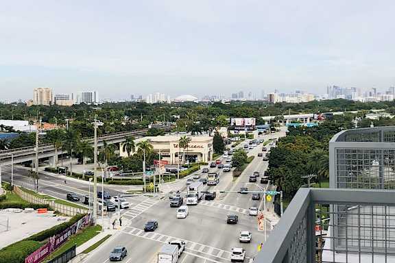 a busy city street with cars and buildings
