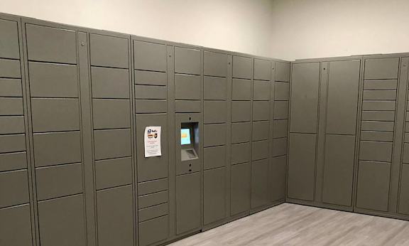 A row of grey lockers in a room.