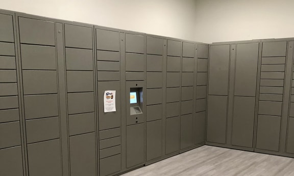 a row of lockers in a room with a machine on the wall