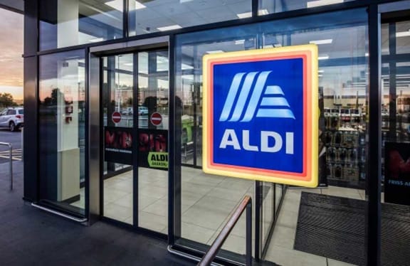 a blue and yellow aldi sign in front of a building