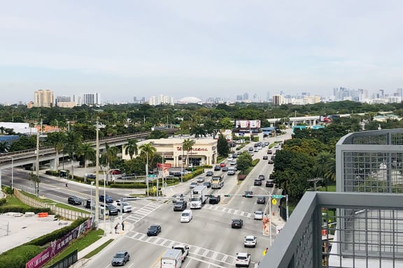 a busy city street with cars and buildings