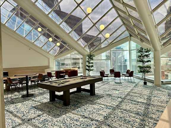 A large room with a glass ceiling and a long table with chairs at 7 West 7th Apartments, Ohio, 45202