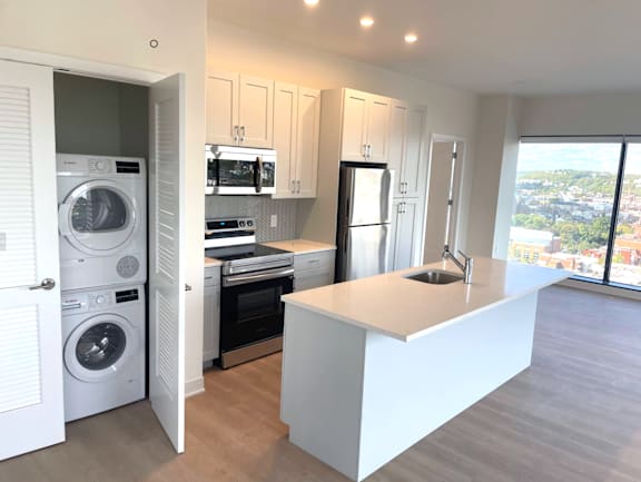 A modern kitchen with a view of the city at 7 West 7th Apartments, Cincinnati, OH