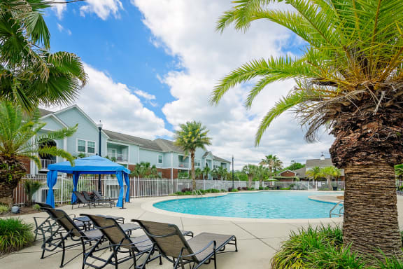 lounge chairs by the pool at Cypress Cove's outdoor area