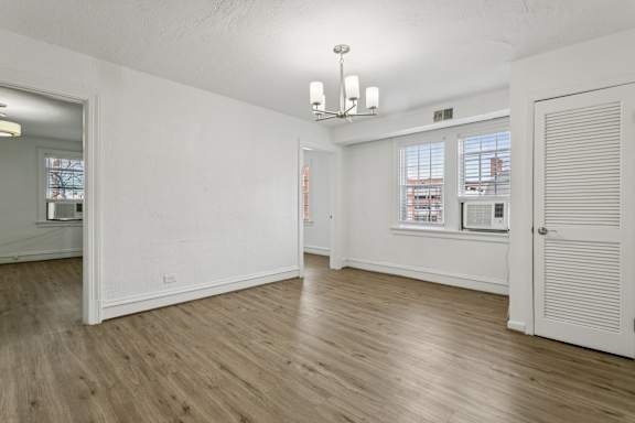 A room with wooden floors and white walls. at Shipyard Shores Apartments, Virginia