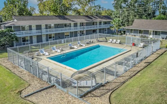 A large swimming pool surrounded by a metal fence.