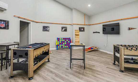 A room with a pool table and air conditioner. at Mayfair Apartments, Kansas City, 64145