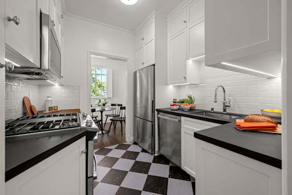 A kitchen with a black and blue checkered floor.