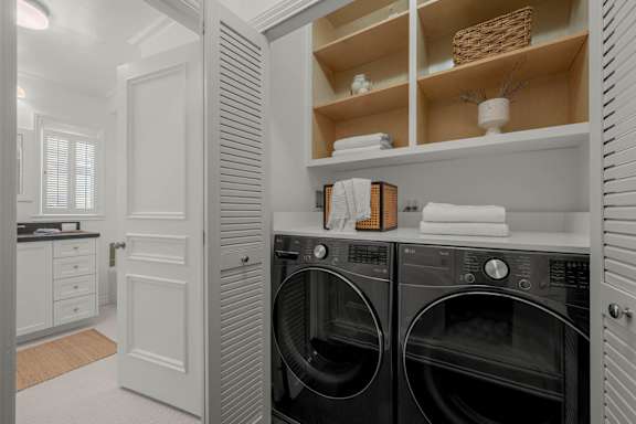 A laundry room with a front loading washing machine and dryer.