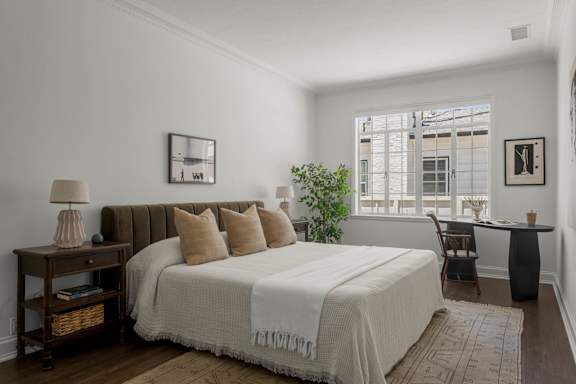 A bedroom with a large bed and a window.
