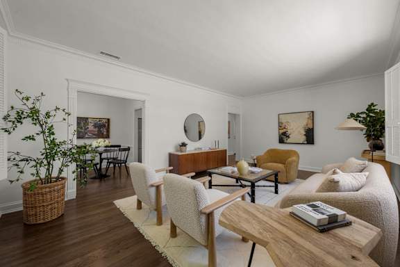 A living room with a wooden table and chairs.