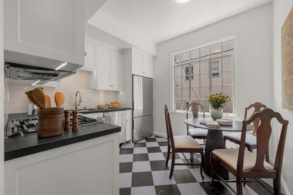 A kitchen with a black and blue checkered floor.