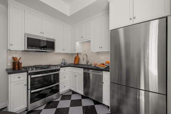 A stylish kitchen with a black and blue checkered floor.