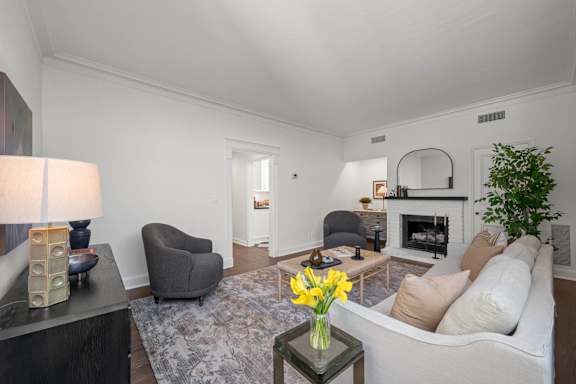 A living room with a fireplace and a couch.