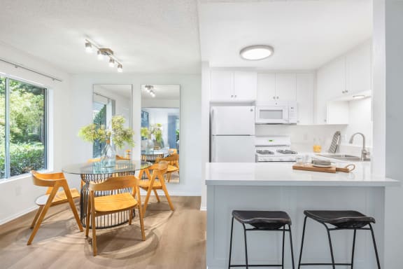 a kitchen and dining room with a table and chairs