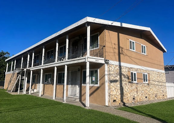 A two-story building with a balcony on the second floor.