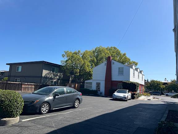 A silver car is parked in a parking lot.