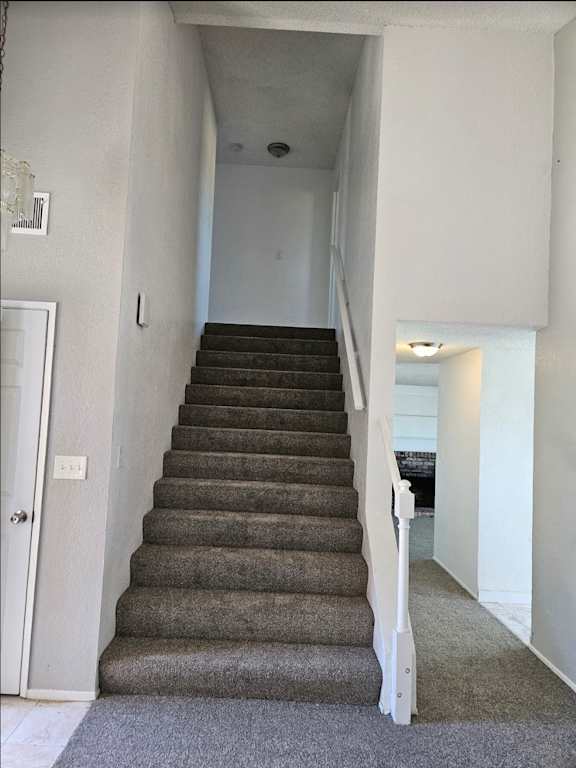 stairs in a home leading up to a hallway with a door