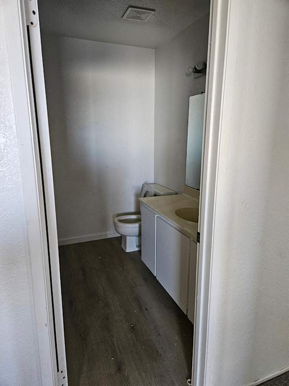 an empty bathroom with a toilet and a sink