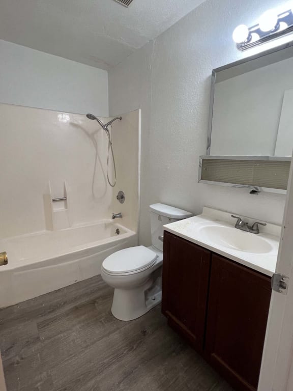 a bathroom with a toilet and a sink and a bath tub