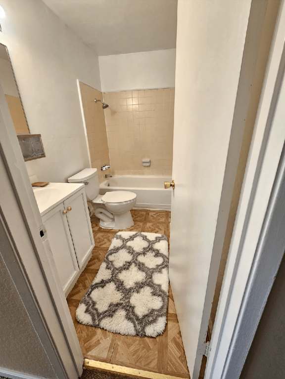 a small bathroom with a toilet and a rug