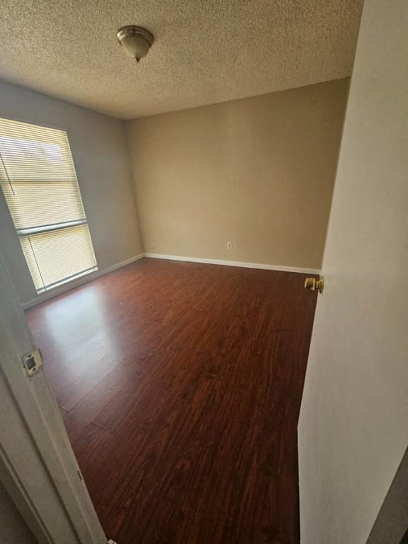 an empty room with a hard wood floor