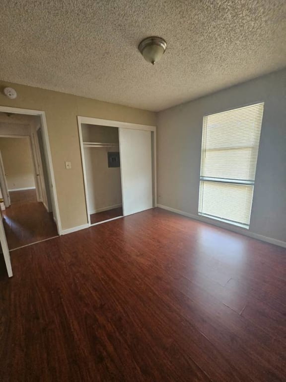 an empty living room with a hard wood floor