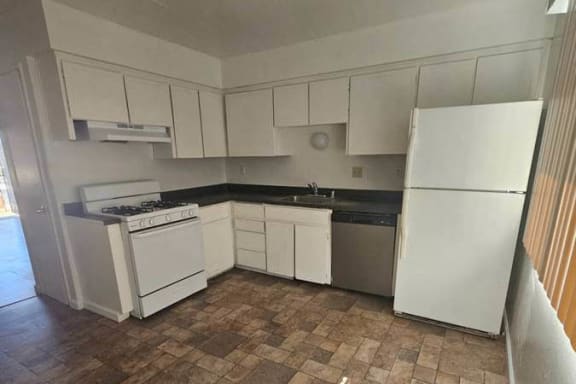 a small kitchen with a stove and a refrigerator
