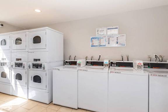 A row of washing machines in a laundromat.