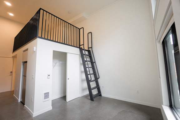 A black and white staircase in a room with white walls.