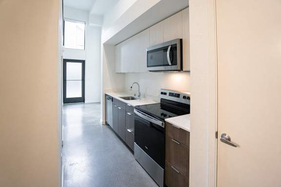 A modern kitchen with a black oven and microwave.