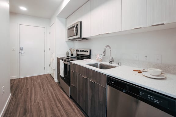 a kitchen with stainless steel appliances and a white counter top