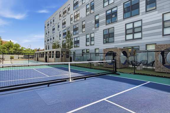 A tennis court is located on the roof of a building.