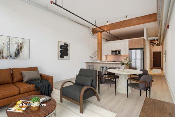 A living room with a brown couch and a white table.