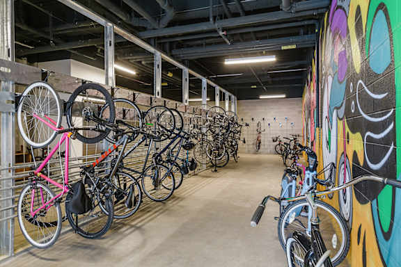 A bike rack full of bikes in a bike shop.