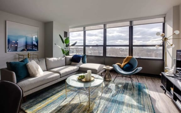 a living room with a large window and a couch and a coffee table