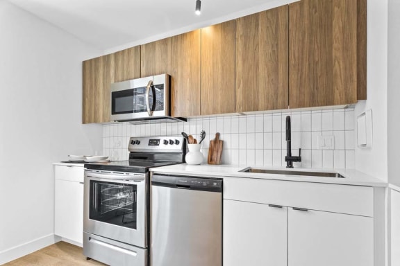 a kitchen with a stove top oven and a sink