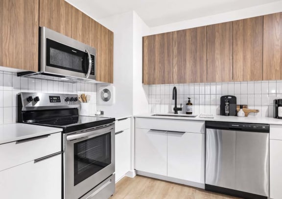 a white kitchen with a stove and a microwave