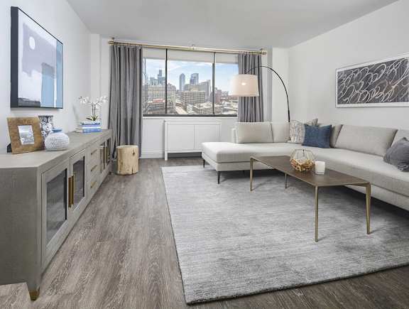 A modern living room with a large window overlooking the city.