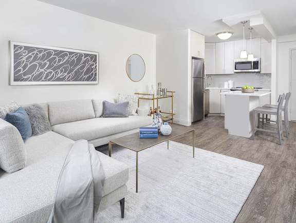 A modern living room with a grey couch and a coffee table.
