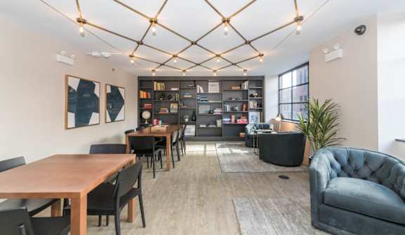 A modern dining room with a wooden table and chairs.