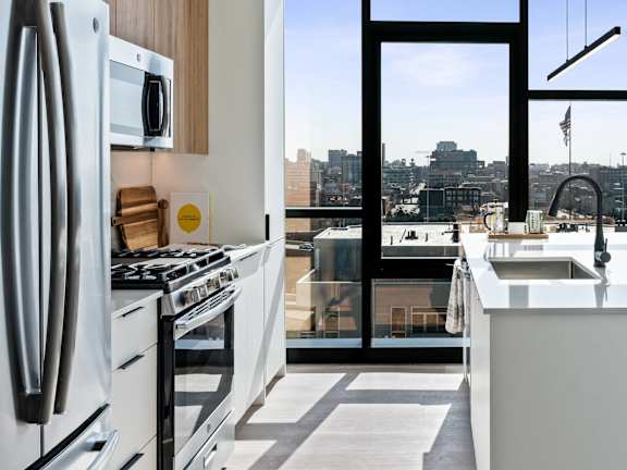 A modern kitchen with a view of the city.